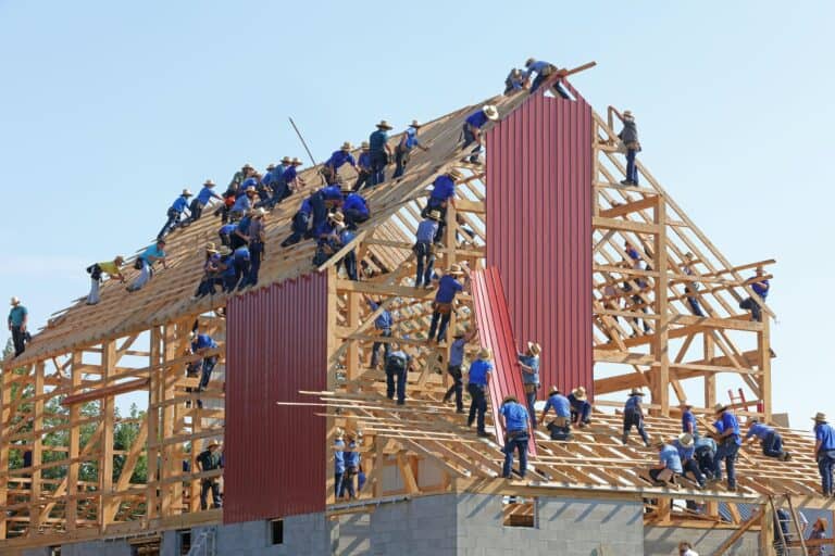 Many people building a house together.